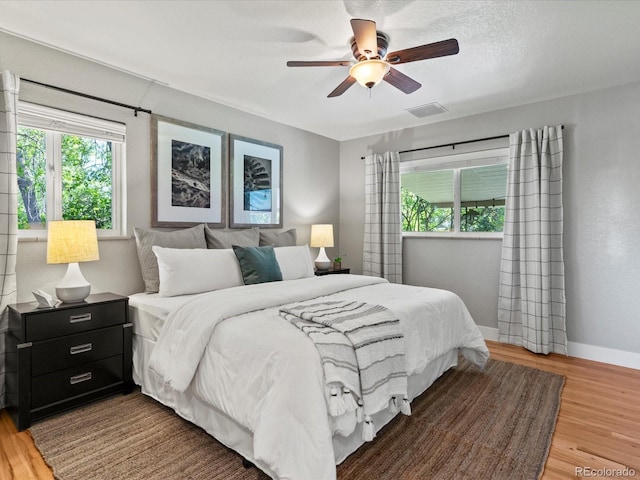 3560 S Glencoe St, Denver, CO 80237 - bedroom with light wood-type flooring, baseboards, and a ceiling fan