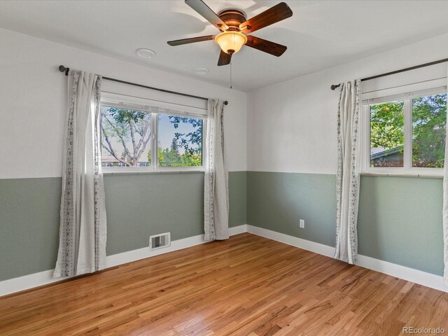 3560 S Glencoe St, Denver, CO 80237 - unfurnished room with healthy amount of natural light, light wood-style flooring, ceiling fan, and baseboards