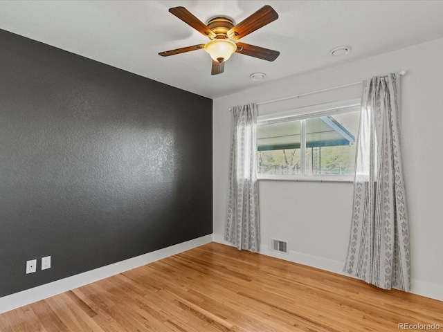 3560 S Glencoe St, Denver, CO 80237 - unfurnished room featuring baseboards, light wood-style flooring, and ceiling fan