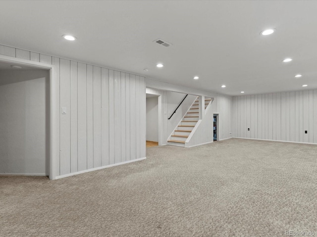 3560 S Glencoe St, Denver, CO 80237 - finished basement with stairs, carpet flooring, recessed lighting, and wood walls