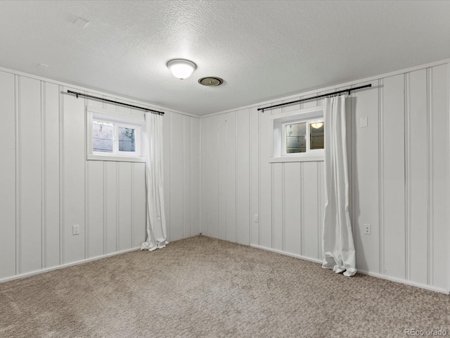 3560 S Glencoe St, Denver, CO 80237 - carpeted empty room with a decorative wall and a textured ceiling