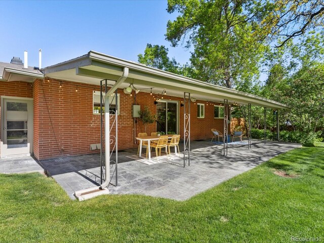 3560 S Glencoe St, Denver, CO 80237 - back of house featuring a patio area, a lawn, and brick siding