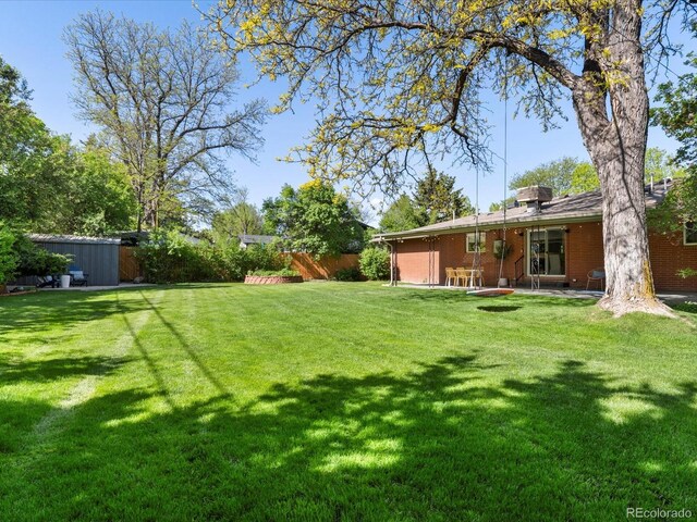 3560 S Glencoe St, Denver, CO 80237 - view of yard with a storage unit, an outbuilding, and a patio