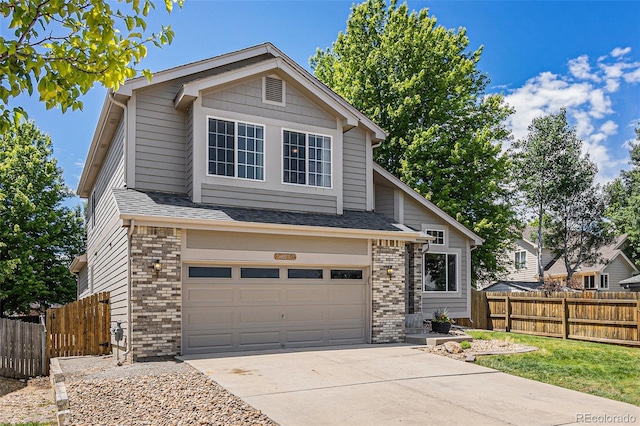 6230 Snowberry Ave, Firestone, CO 80504 - view of front of home featuring brick siding, an attached garage, and concrete driveway