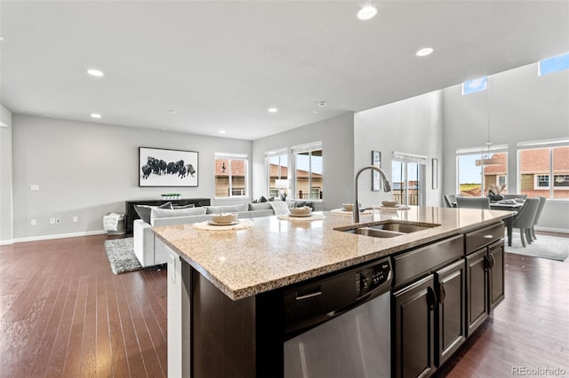 18180 W 84th Pl, Arvada, CO 80007 - kitchen with stainless steel dishwasher, open floor plan, dark wood finished floors, healthy amount of natural light, and recessed lighting