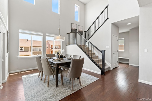 18180 W 84th Pl, Arvada, CO 80007 - dining room featuring a high ceiling, wood finished floors, and stairs