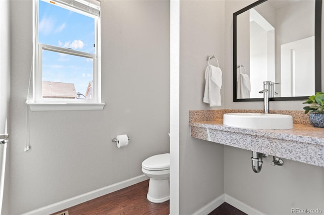 18180 W 84th Pl, Arvada, CO 80007 - half bathroom with a sink and wood finished floors