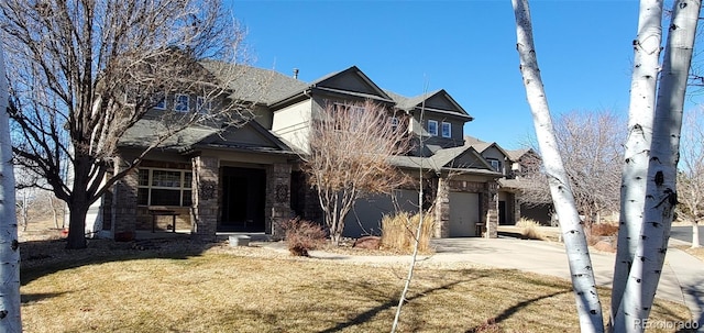 view of front of property with a garage and a front lawn