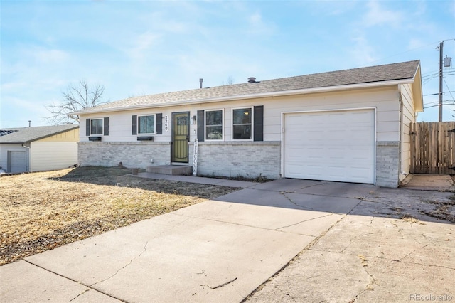 2240 Flintwood Dr, Colorado Springs, CO 80910 - ranch-style home featuring brick siding, a garage, and driveway