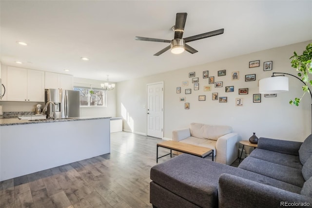 2240 Flintwood Dr, Colorado Springs, CO 80910 - living room featuring a chandelier, ceiling fan, dark wood-style flooring, and recessed lighting