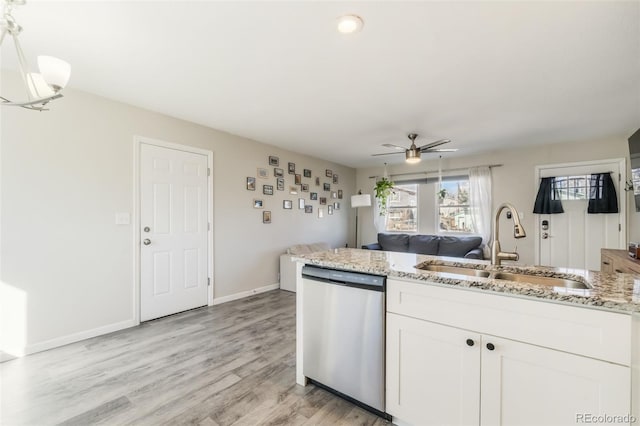 2240 Flintwood Dr, Colorado Springs, CO 80910 - kitchen featuring stainless steel dishwasher, light stone counters, ceiling fan, white cabinetry, and open floor plan