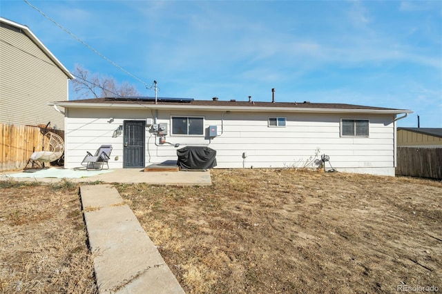 2240 Flintwood Dr, Colorado Springs, CO 80910 - rear view of property featuring a patio, roof mounted solar panels, and a fenced backyard