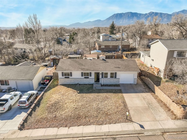 2240 Flintwood Dr, Colorado Springs, CO 80910 - view of front of house featuring driveway, a residential view, a mountain view, and an attached garage