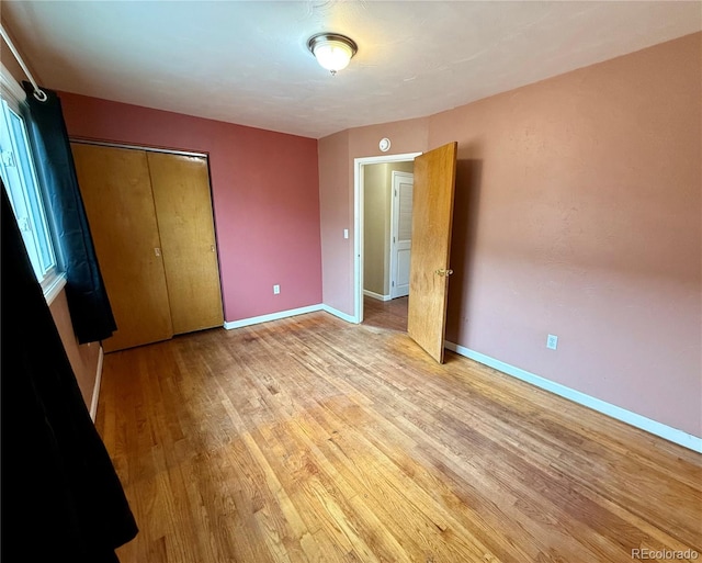 unfurnished bedroom featuring a closet and light hardwood / wood-style floors