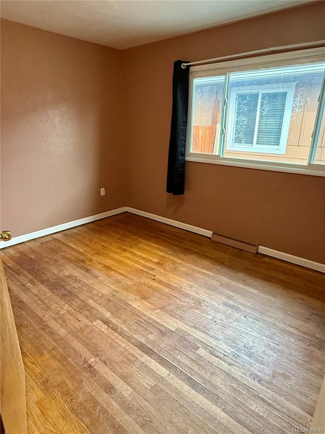 spare room featuring light hardwood / wood-style flooring