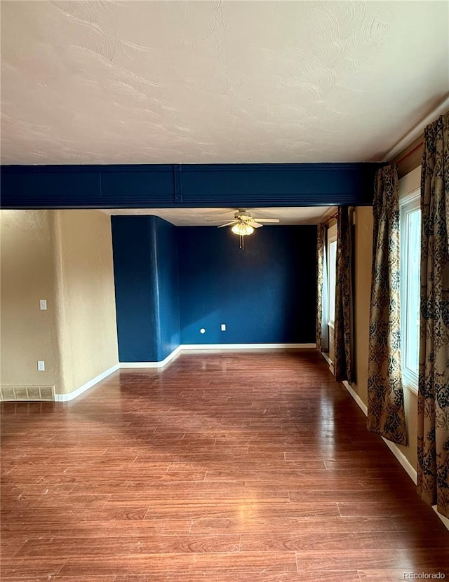 empty room featuring hardwood / wood-style floors and ceiling fan