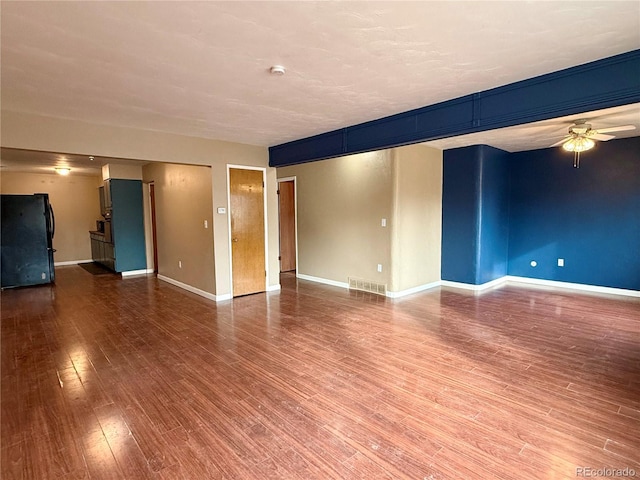 empty room with hardwood / wood-style flooring and ceiling fan