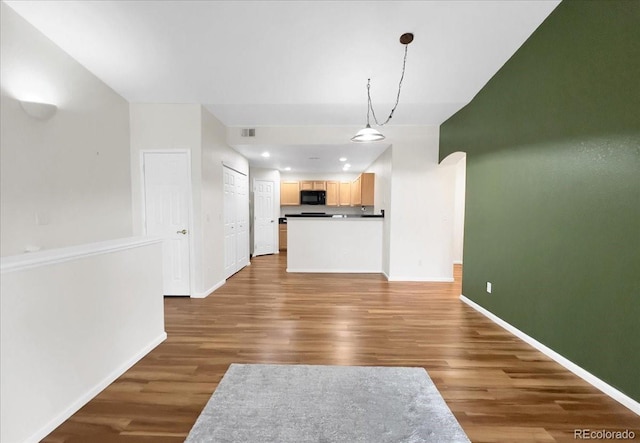 unfurnished living room with baseboards, recessed lighting, visible vents, and wood finished floors