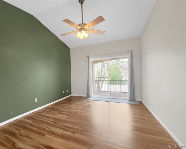 unfurnished room with lofted ceiling, baseboards, ceiling fan, and wood finished floors