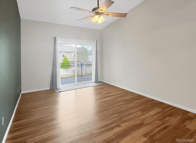 unfurnished room featuring baseboards, vaulted ceiling, ceiling fan, and wood finished floors