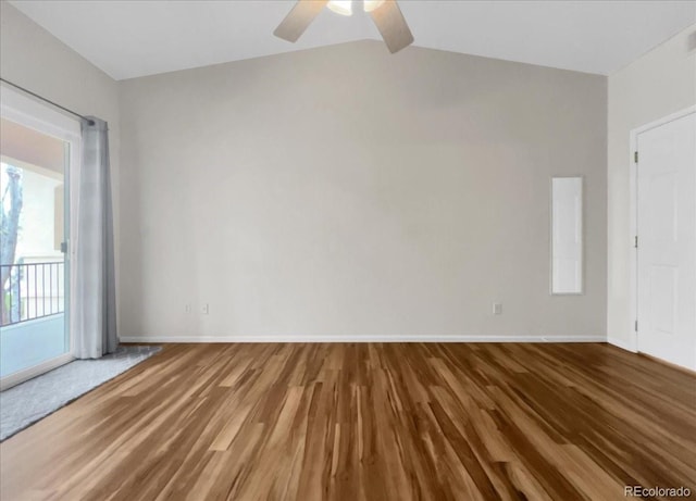 unfurnished room with lofted ceiling, baseboards, a ceiling fan, and wood finished floors