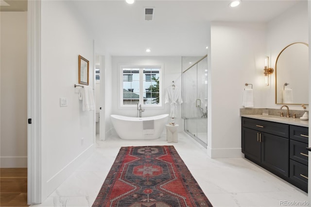 bathroom featuring vanity and independent shower and bath