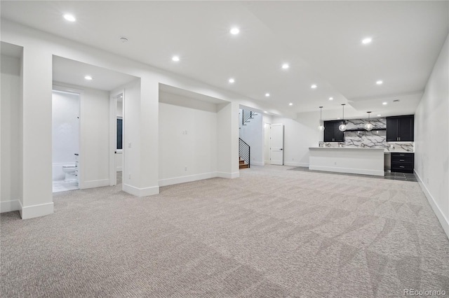 unfurnished living room featuring light colored carpet