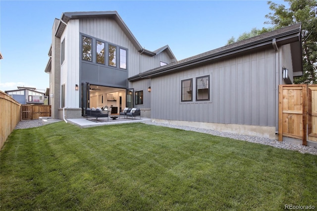 back of house featuring a yard, an outdoor hangout area, and a patio area