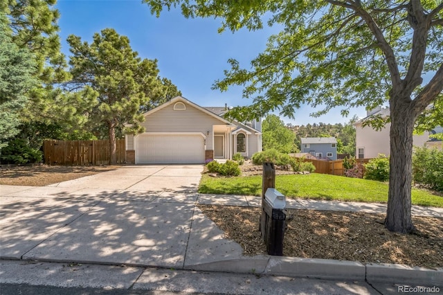 1826 Palm Dr, Colorado Springs, CO 80918 - view of front facade with an attached garage, concrete driveway, and brick siding