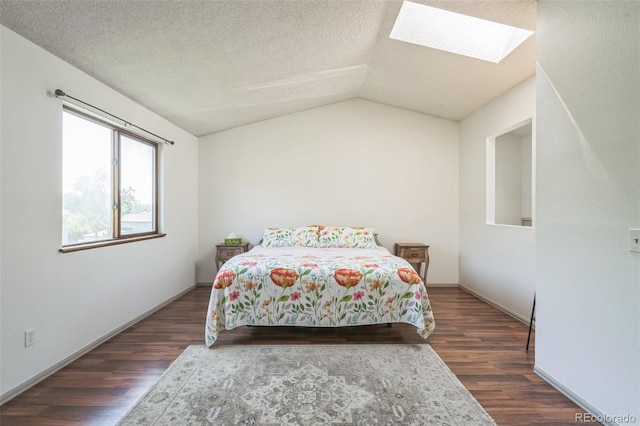 1826 Palm Dr, Colorado Springs, CO 80918 - bedroom featuring a skylight, dark wood finished floors, vaulted ceiling, and a textured ceiling