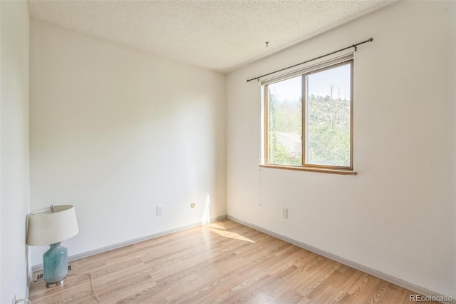 1826 Palm Dr, Colorado Springs, CO 80918 - unfurnished room with wood finished floors and a textured ceiling