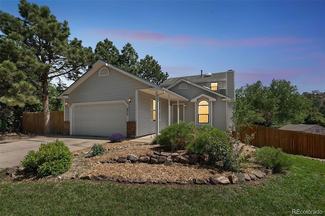 1826 Palm Dr, Colorado Springs, CO 80918 - view of front of house with a garage, driveway, and a porch