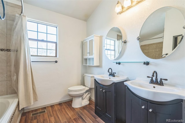 1826 Palm Dr, Colorado Springs, CO 80918 - bathroom with two vanities, wood finished floors, and shower / bathtub combination with curtain
