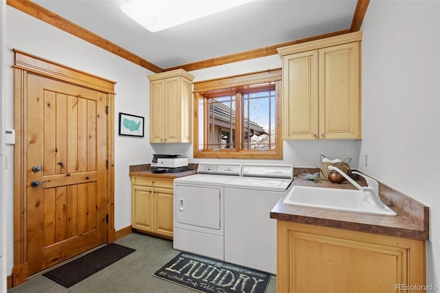 laundry area featuring independent washer and dryer, crown molding, cabinet space, a sink, and carpet floors