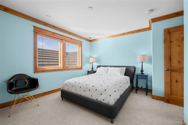 carpeted bedroom with crown molding and baseboards
