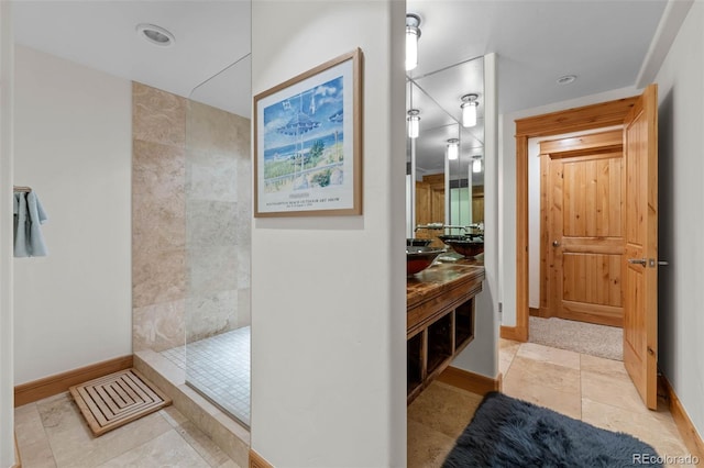 bathroom with vanity, baseboards, walk in shower, and recessed lighting