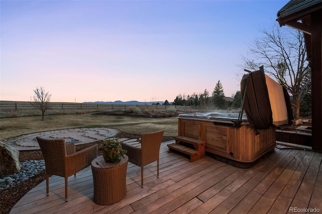 wooden deck featuring a fenced backyard and a hot tub