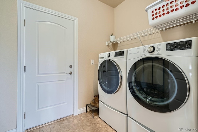 laundry area with light tile patterned flooring and washing machine and dryer