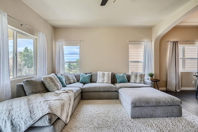 living room featuring ceiling fan and hardwood / wood-style flooring