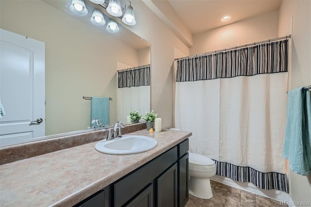 bathroom featuring tile patterned flooring, toilet, and vanity