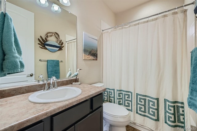 bathroom with toilet and vanity