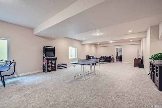 playroom featuring light carpet and a textured ceiling