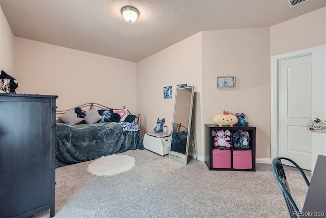 bedroom featuring carpet and a textured ceiling