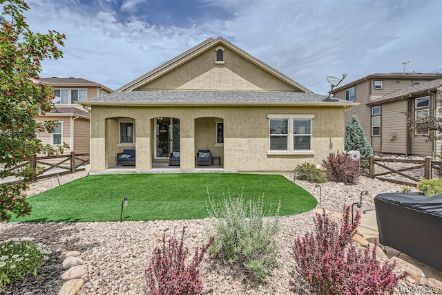 rear view of house featuring a yard