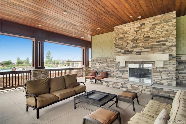 view of patio featuring an outdoor living space with a fireplace