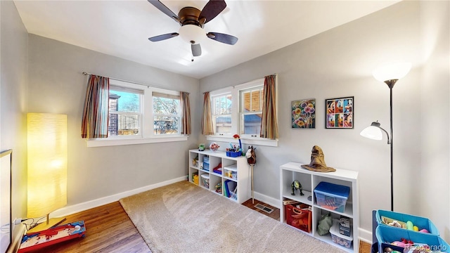 game room with visible vents, ceiling fan, baseboards, and wood finished floors