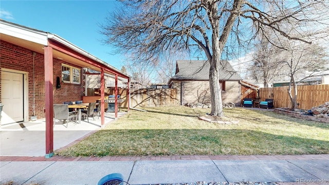 view of yard featuring a patio area and a fenced backyard