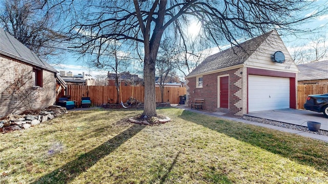 view of yard with a detached garage and fence