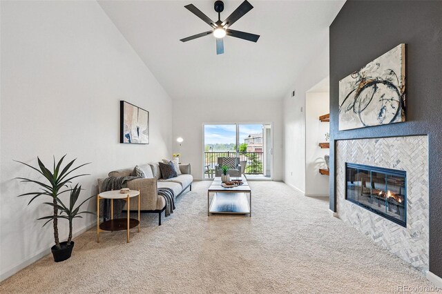 living room with carpet flooring, a ceiling fan, high vaulted ceiling, a fireplace, and baseboards