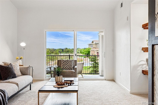 carpeted living room featuring baseboards